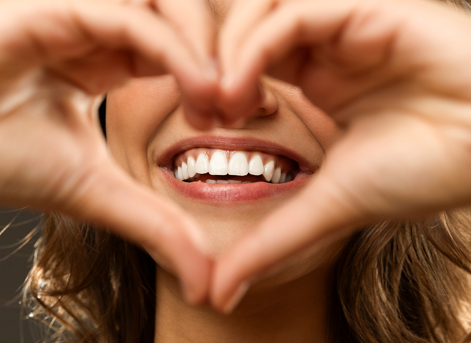 Smiling face framed by hands