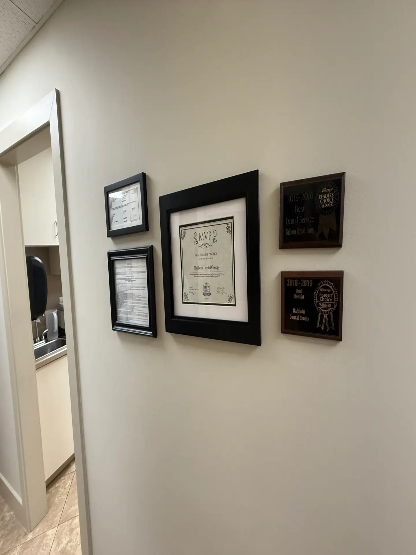 Framed certificates and awards on wall