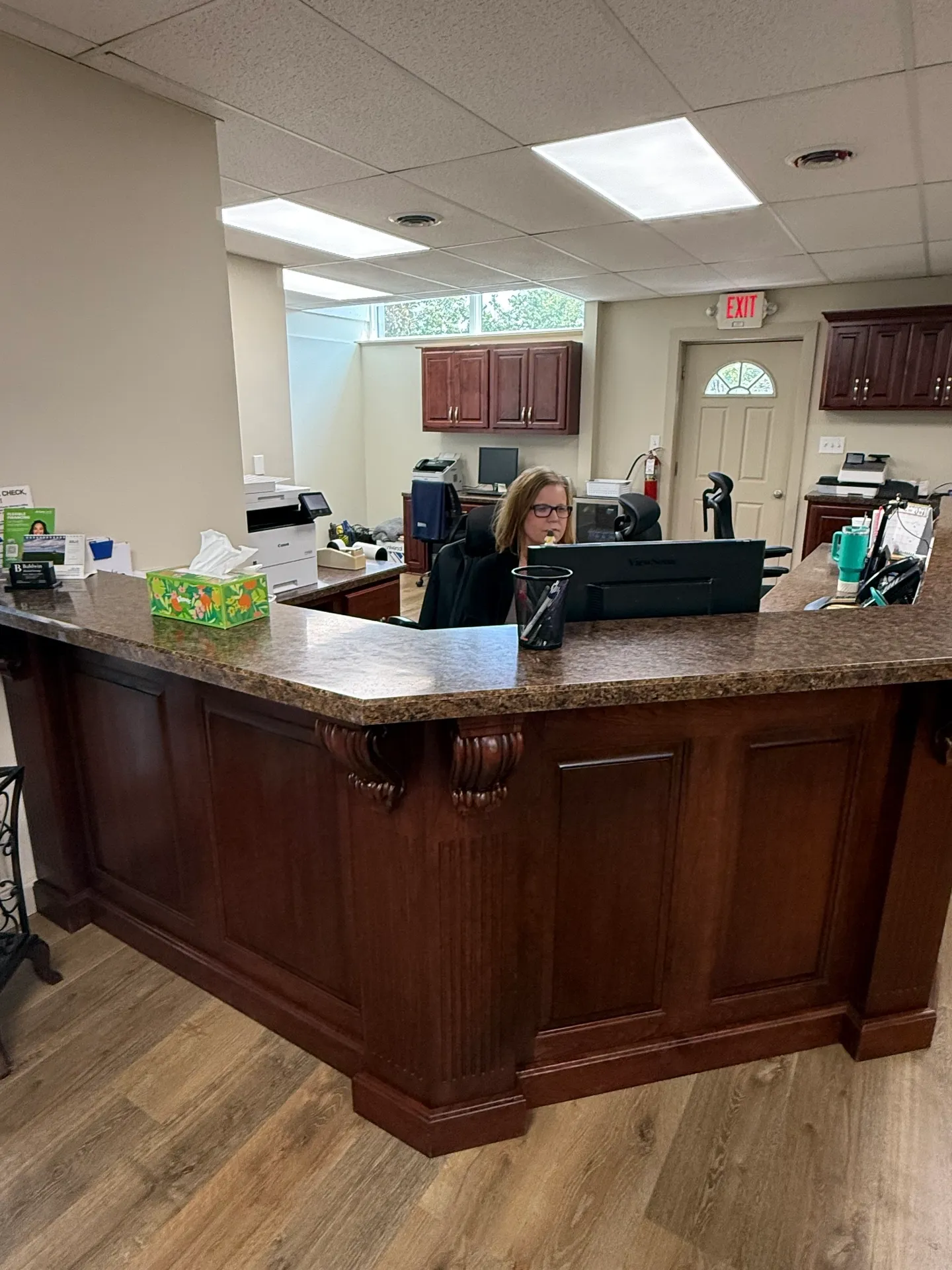 Woman seated at office reception desk